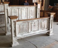 an old white wooden bed frame in a room