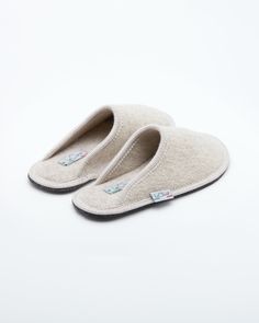 Description: The Le Clare women's Stella in beige is the classic "hotel slipper" reimagined in luxurious boiled wool. This quintessential slipper provides delicate comfort and has been handcrafted, only for the most discerning, the Stella will not disappoint. Featuring our premium Italian boiled wool fiber, the slipper gently conforms to your foot for cozy comfort. The natural elasticity of our wool bounces back to its original shape, giving the slipper lasting appeal with a customized fit. This Hotel Slippers Luxury, Wool Slip-on Slippers With Leather Sole, Wool Slip-on Indoor Slippers, Wool Indoor Slip-on Slippers, Indoor Wool Slip-on Slippers, Cozy Beige Slip-on Slippers, Comfortable Wool Slip-on Slippers, Beige Closed Toe Cushioned Slippers, Cream Slip-on Slippers With Cushioned Footbed