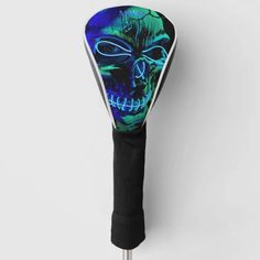 a blue and green skull on a black headcover with white lines around it