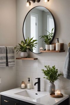 a bathroom sink with a mirror above it and two candles on the counter next to it