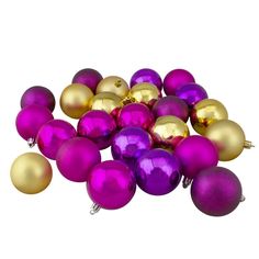 a pile of purple and gold christmas ornaments