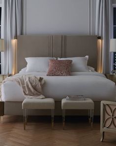 a bedroom with a large bed and two side tables