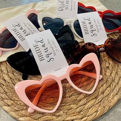 four pairs of sunglasses with price tags on them sitting on a woven basket next to each other