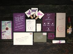 the wedding stationery is laid out with wine bottles and other things to put on it