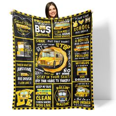 a woman holding up a yellow school bus blanket