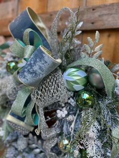 a christmas wreath with green and silver decorations