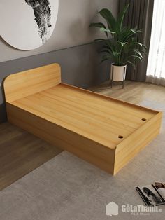 a wooden bed frame sitting on top of a floor next to a potted plant