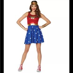 a woman in a wonder costume standing with her hands on her hips