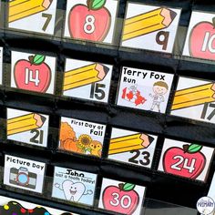 a display case filled with lots of different pictures and numbers for children to use in the classroom