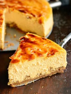 a piece of cheesecake sitting on top of a wooden table