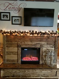 the fireplace is decorated with christmas lights and decorations