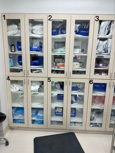 the inside of a medical cabinet with many items labeled in blue and white on it