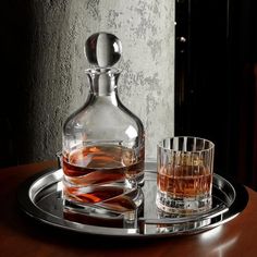 two glasses and a decanter on a tray