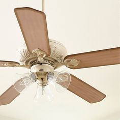 a ceiling fan with three light bulbs and two wooden blades on the top of it