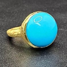 14k solid yellow gold hammered ring with 13.5 ct. 16.0 mm round shape natural AAA turquoise. This item can also be ordered in rose or white gold with different color gemstones such as, green tourmaline, pink tourmaline, rutilated quartz, onyx, labradorite, white agate, all colors of chalcedony and aquamarine, please contact for a quote as each gemstone varies in price. I am a manufacturer of fine jewelry for over thirty years, loyalty and customer satisfaction have always been my ultimate goals. Gold Turquoise Ring With Gemstone, Elegant Gold Turquoise Round Ring, Handmade Yellow Gold Turquoise Ring, Handmade Turquoise Ring In Yellow Gold, 14k Gold Turquoise Round Ring, 14k Gold Turquoise Ring, Handmade Yellow Gold Dome Ring With Round Shape, Handmade Yellow Gold Dome Ring, Hammered Ring