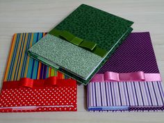 four different colored papers with bows on them