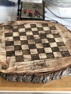 a wooden chess board sitting on top of a table