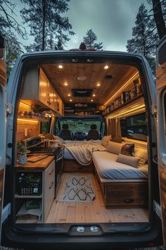 the interior of an rv with its bed pulled up to it's rear end