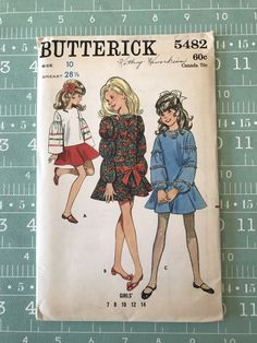 a book with two girls in dresses on it