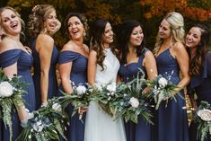 a group of women standing next to each other with bouquets in front of them