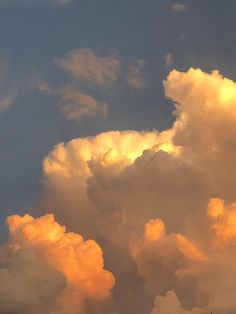 an airplane is flying in the sky with clouds