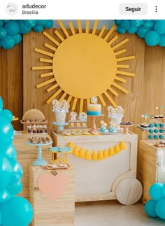 a dessert table with blue and yellow balloons