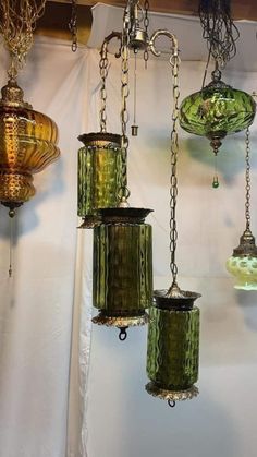 several green glass lamps hanging from the ceiling