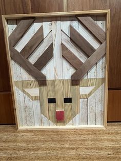 a wooden frame with a face made out of wood