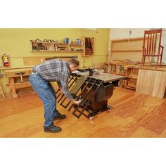 a man working on a piece of furniture