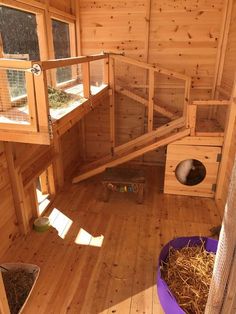 the inside of a small wooden house with lots of windows