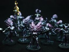 the miniature figurines are all painted in different colors and sizes, including purple hair