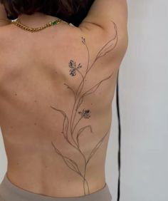 the back of a woman's body with flowers on it