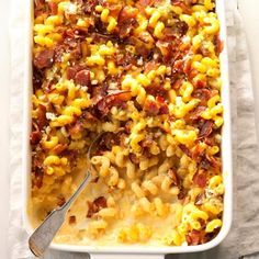 a casserole dish filled with macaroni and cheese, topped with bacon