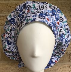 Bouffant Flowered scrub caps Women's Blues  Chemo Cap Surgical  Veterinarian Nurse Cap Lined with white satin. Women's Bouffant style blue floral print with  coordinating headband. -Large size (average adult) -Elastic in back for a comfortable fit -Larger size to hold most hair styles -Adjustable toggle -Machine washable, air dry to reduce wrinkles and shrinkage -High quality construction with 100% cotton fabric -Perfect gift for the healthcare worker in your life! -Hand-cut and hand-sewn with love in the USA * The photo was taken of the first hat made and is an example   of the one that you will receive. No two hats are exactly alike   as far as placement of patterns and pictures on your hat.  Because this is a personal item, I cannot accept returns or exchanges.       Please read the des Scrub Caps Women, Womens Scrub Hat, Nurse Cap, Bouffant Scrub Caps, Bouffant Scrub Hat, American Hairstyles, Nursing Cap, Surgical Scrub Hats, Chemo Caps