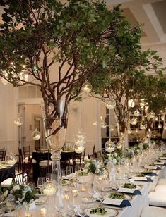 a long table is set up with place settings and centerpieces for an elegant dinner