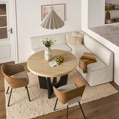 a living room filled with furniture and a white couch next to a wooden coffee table