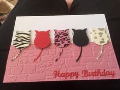 a woman holding up a card with three cats on it and the words happy birthday