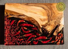 a wooden cutting board with red peppers on it