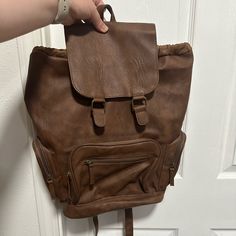 Mossimo Brown Faux Leather Backpack W Zipper Pockets - Perfect Condition, Never Used - Brown Faux Leather With Brass Looking Accents - Zipper Pockets - Cinchable Large Pocket And Snap Top Flap - Adjustable Straps - Zipper Pocket & Open Pockets Inside Trendy Brown Backpack With Zipper Pocket, Casual Faux Leather Backpack For School, Casual Faux Leather School Backpack, Casual Faux Leather Backpack For Travel, Trendy Brown Leather Backpack For On-the-go, Casual Faux Leather Backpack With Adjustable Strap, Casual Faux Leather Satchel Backpack, Casual Faux Leather Rectangular Backpack, Casual Rectangular Faux Leather Backpack