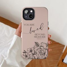 a person holding up a phone case that says you are loved beyond measure