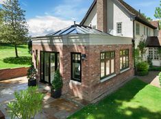 a large brick house with a glass roof