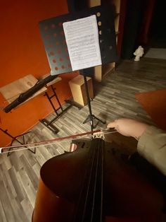 an instrument is sitting on the floor in front of a music stand with sheet music