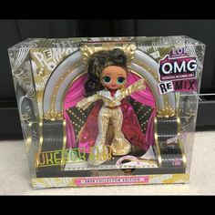 a doll in a box on a white surface with an advertisement for the new toy