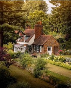 the house is surrounded by trees and flowers