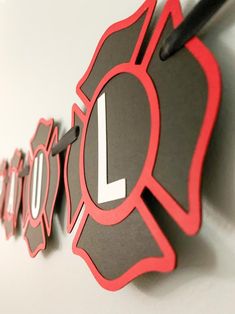 this is an image of a wall clock with the letter l in red and black