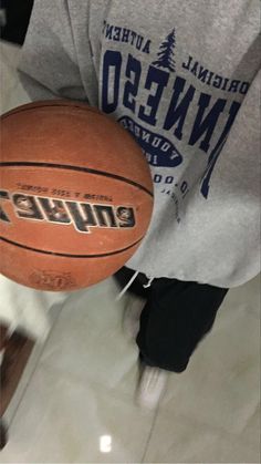 a person holding a basketball in their hand