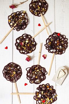 chocolate covered lollipops on sticks with hearts and candy in the middle for valentine's day