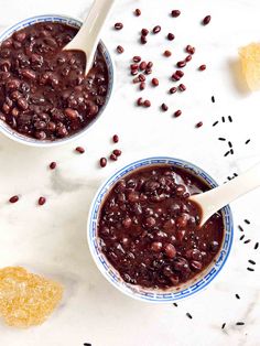 two bowls filled with beans next to crackers