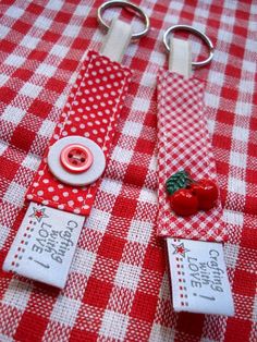 two red and white checkered table cloth with buttons on each side, one has a strawberry