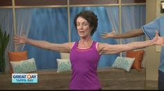 an older woman is doing yoga with her arms stretched out in front of the camera